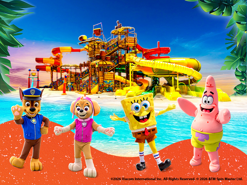 SpongeBob, Patrick, Chase, and Skye are in the foreground, with the slides of the Jungle Splash at Tropical Islands in the background.